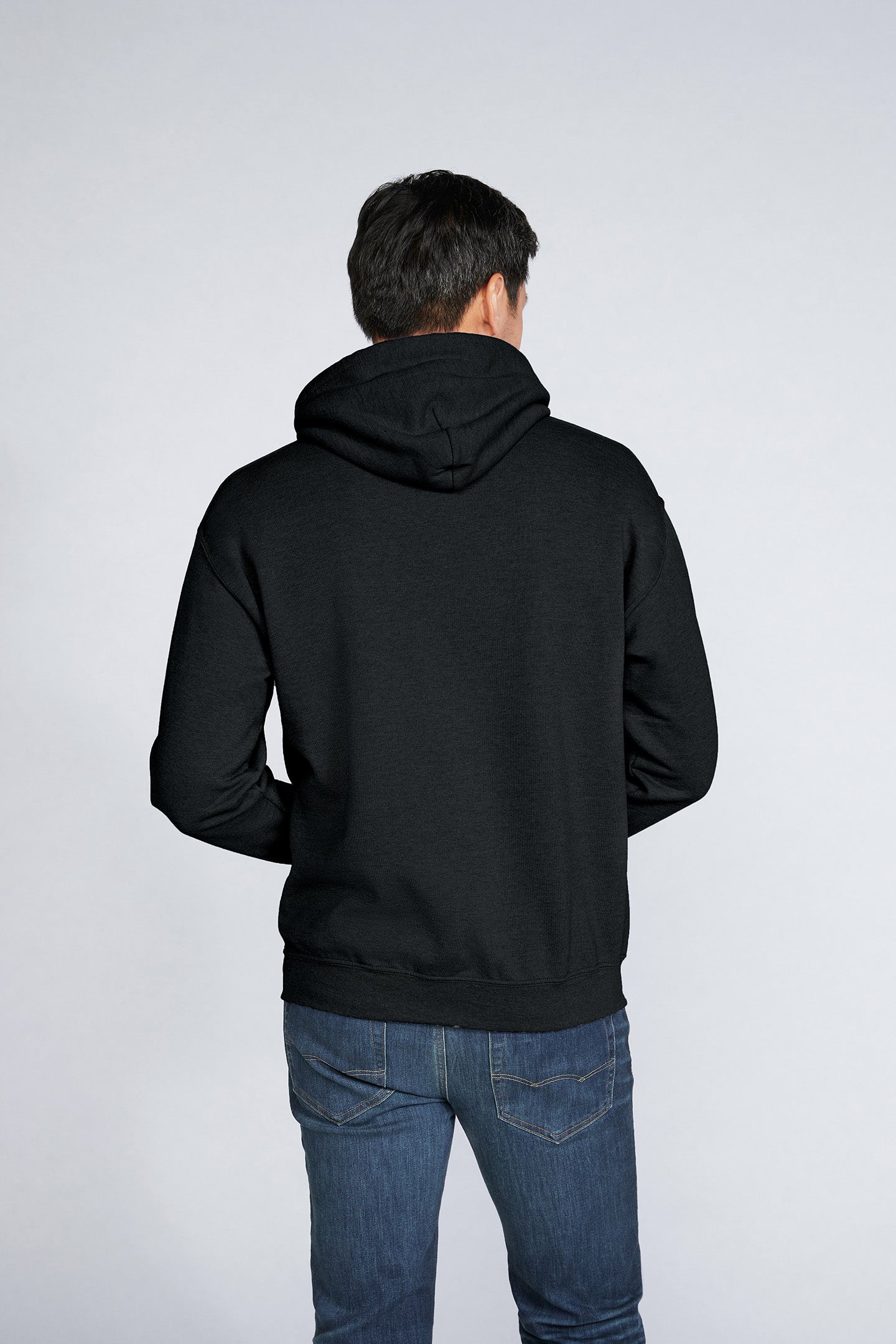 Hooded Sweatshirt | Heavy Blend in black, back view of a man wearing a double-lined hood and pouch pocket sweatshirt.