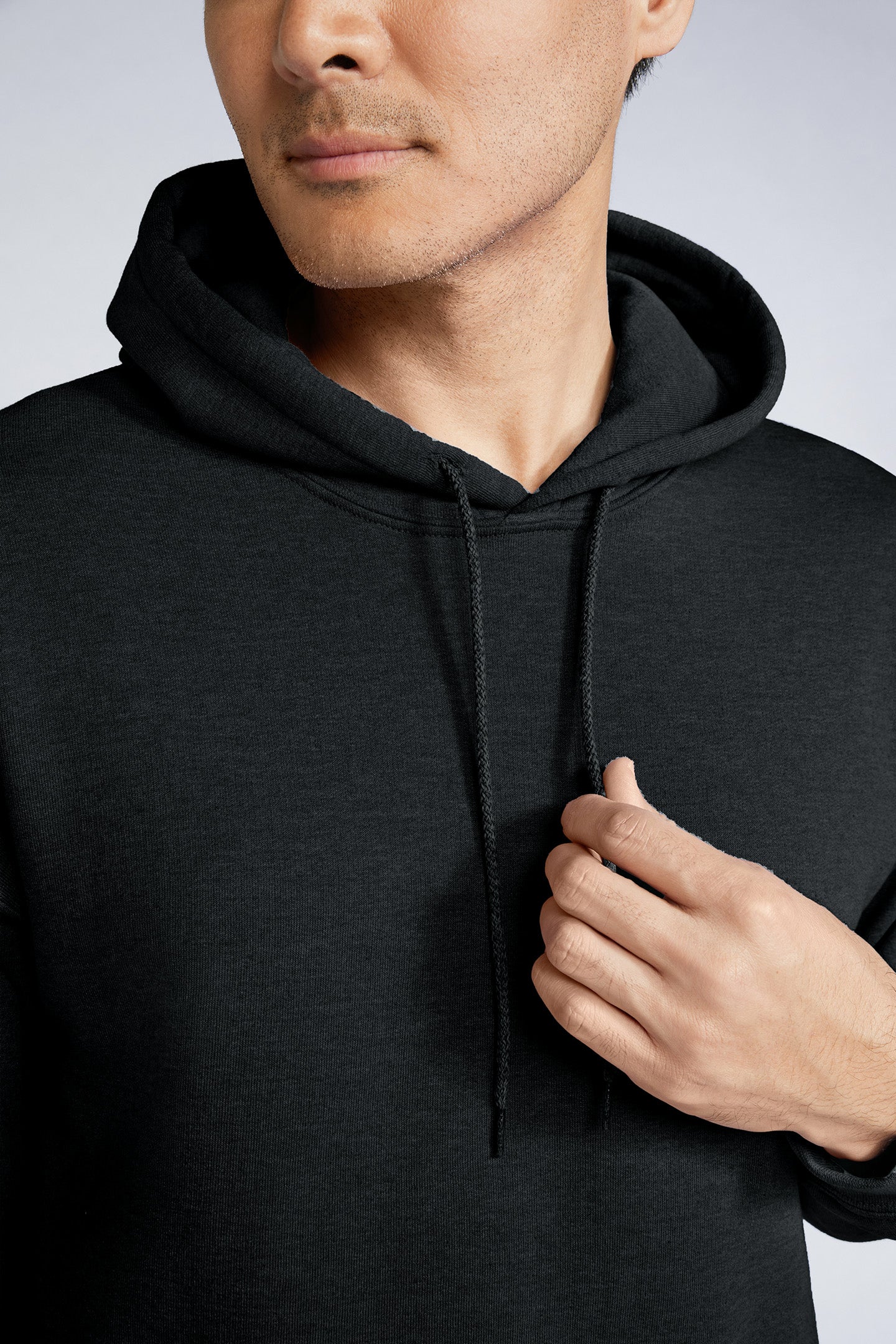 Hooded Sweatshirt | Heavy Blend black unisex pullover with double-lined hood and drawcord close-up on model