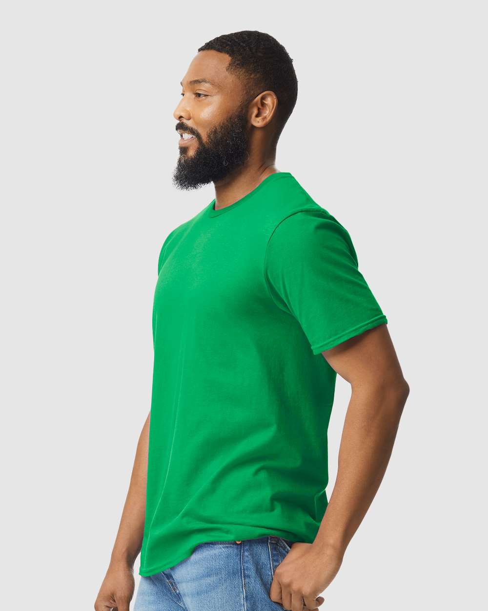 Men / Unisex Colour Shirt Softstyle 100% Cotton Tee in vibrant green worn by male model side view.