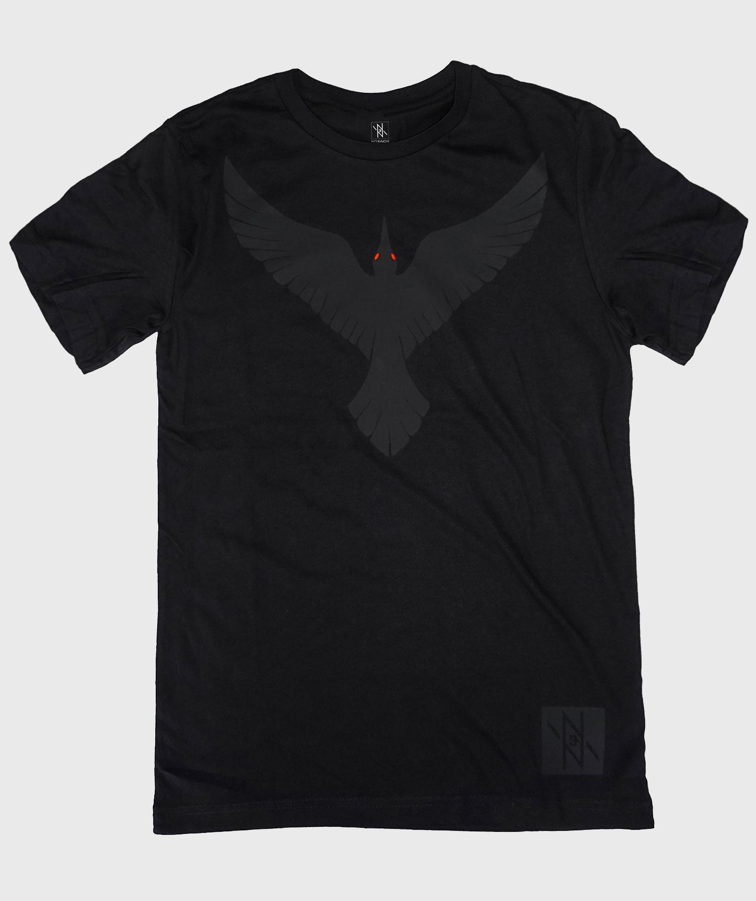 Front view of the Noir et Noir Raven unisex T-shirt, featuring a bold black-on-black raven design. Ideal for modern, stylish wear for all genders. Available now in the Design Collection.