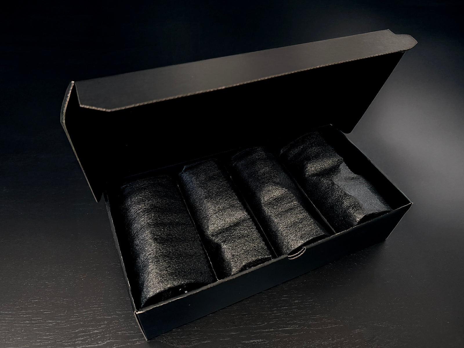 Custom Engraved Wine Glass – 11oz Tulip Design set of four glasses in a black gift box with black fabric wraps.