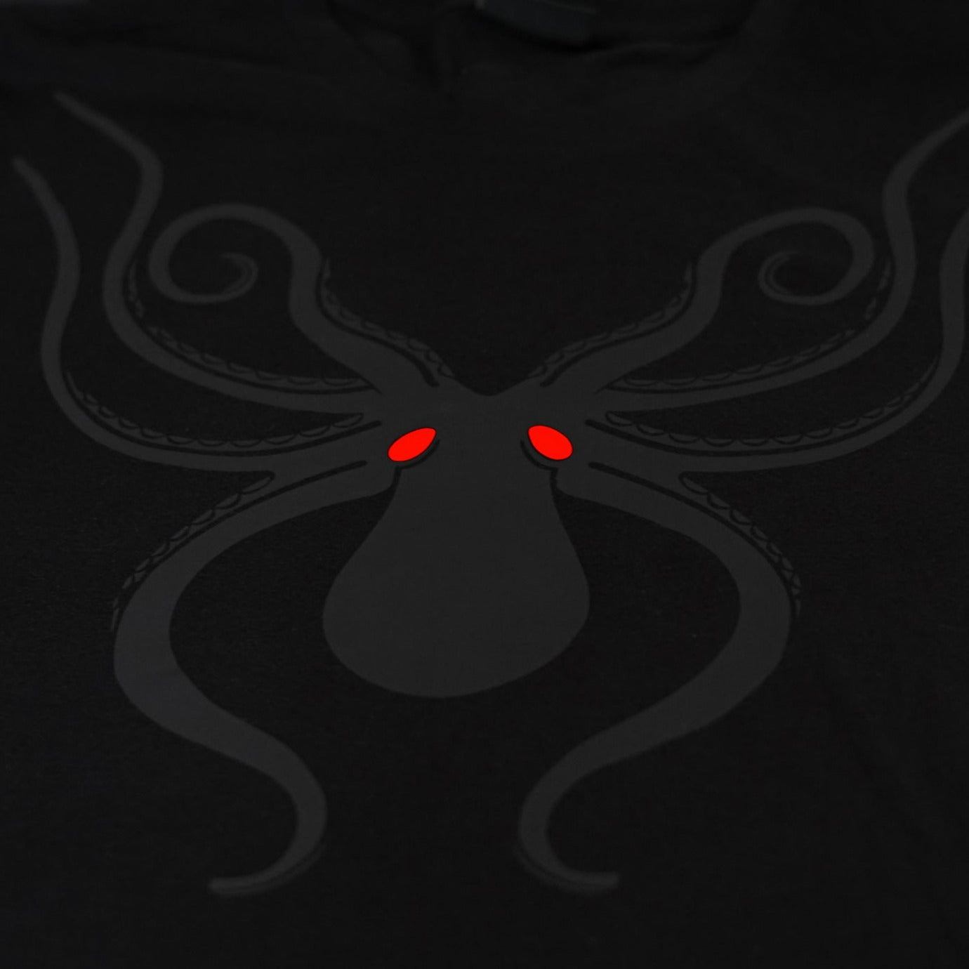 Close-up of the Noir et Noir Octopus unisex T-shirt, highlighting the intricate black-on-black octopus print. Perfect for those who appreciate subtle yet striking style. Part of the exclusive Design Collection