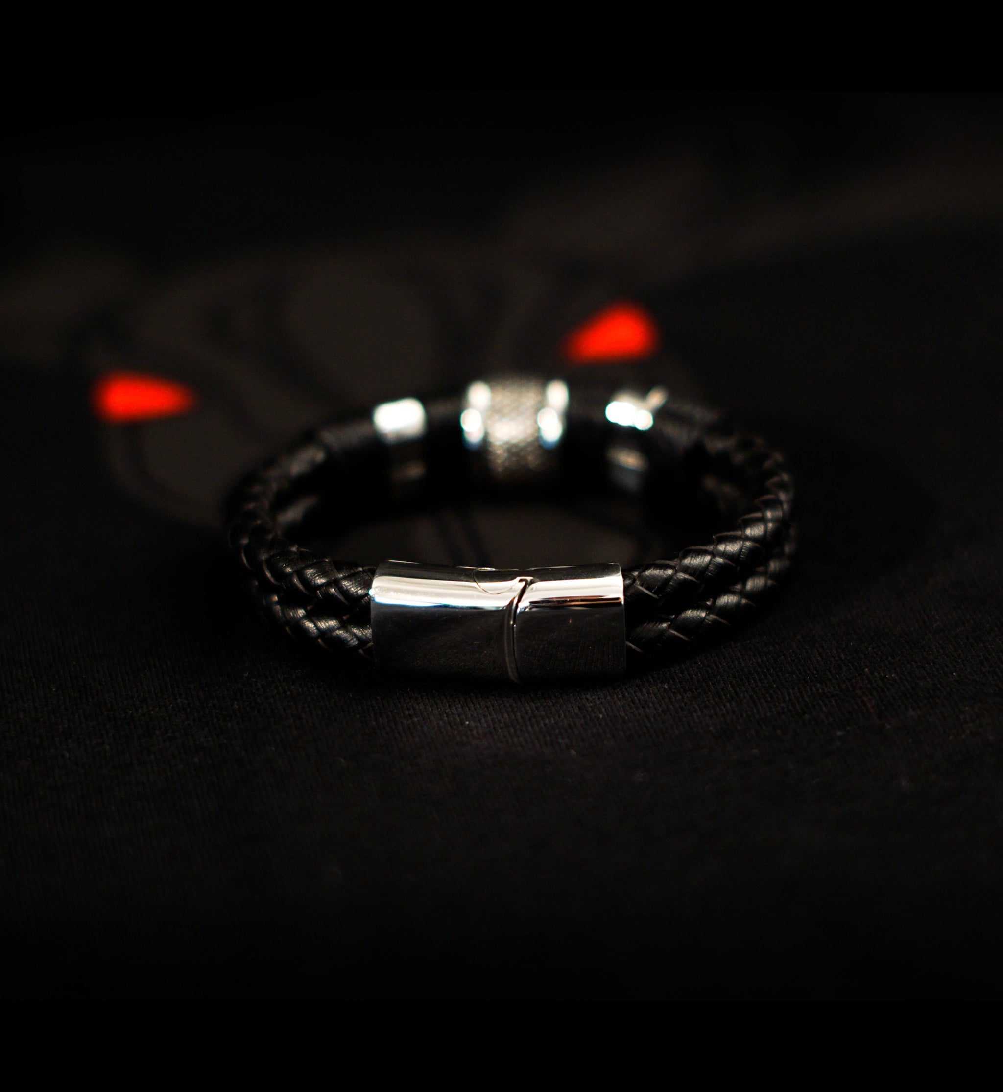 Black Woven Leather Bracelet with braided leather, stainless steel beads, and magnetic lobster clasp on black background.