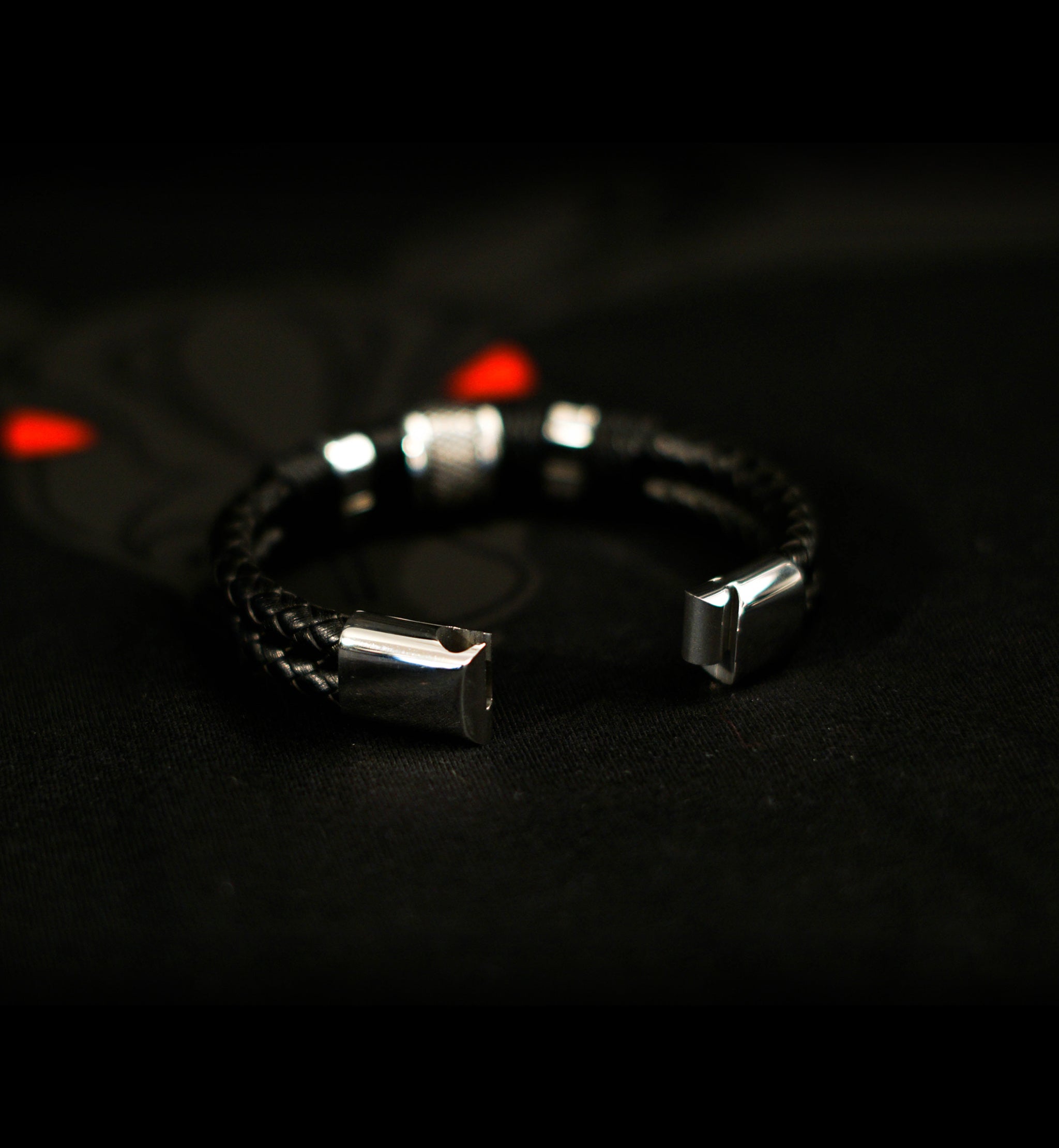 Black Woven Leather Bracelet with stainless steel beads, woven leather rows, and magnetic clasp on black background.