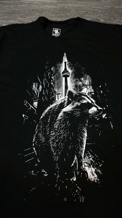 Close-up of the Noir et Noir Toronto Urban Raccoon T-shirt design, highlighting the detailed and intricate black-on-black raccoon print. Ideal for those who appreciate subtle yet artistic style. Part of the exclusive Toronto Collection