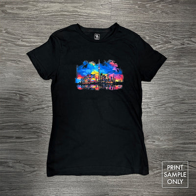 Women's Fit Softstyle 100% Cotton Tee Black with colorful city skyline graphic on front flat on wooden floor