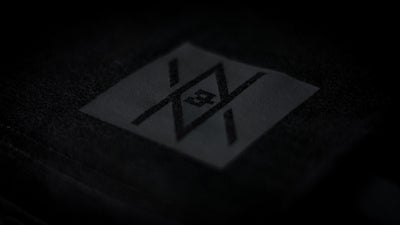 Detailed view of the Noir et Noir Downtown Toronto Minimalist Map T-shirt's black-on-black logo, showcasing the precise and high-quality print. Essential for a modern, minimalist wardrobe. Featured in the Toronto Collection