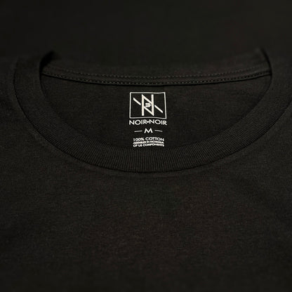 Close-up of the Noir et Noir branding label and collar detail on the Moose unisex T-shirt, showcasing premium craftsmanship and attention to detail. Part of the elegant Design Collection.