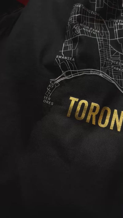 "Video close-up of the Noir et Noir Downtown Toronto Minimalist Map T-shirt, showcasing the intricate map design, the high-quality black-on-black print, and the gold lettering that spells 'Toronto.' The video highlights the premium craftsmanship and attention to detail