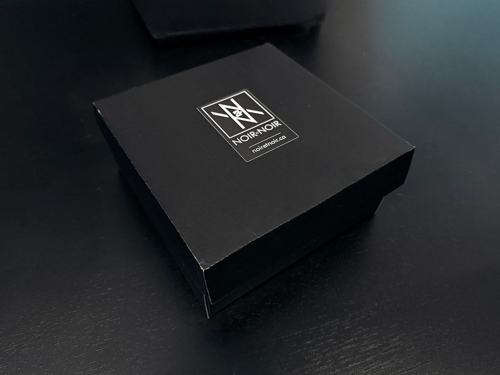 Minimalist Custom Engraved Whisky Glass 10oz shown with sleek black gift box on dark surface, Nordic-inspired design.