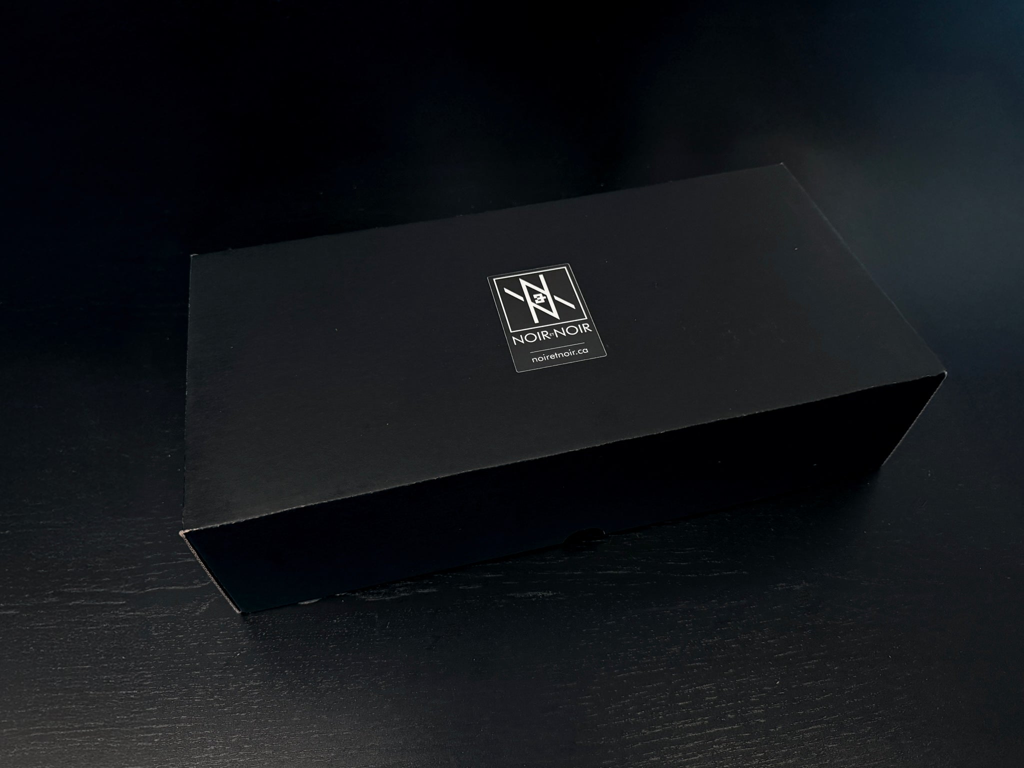 Custom Engraved Wine Glass – 11oz Tulip Design gift box with logo on black surface, elegant packaging for wine glass set.