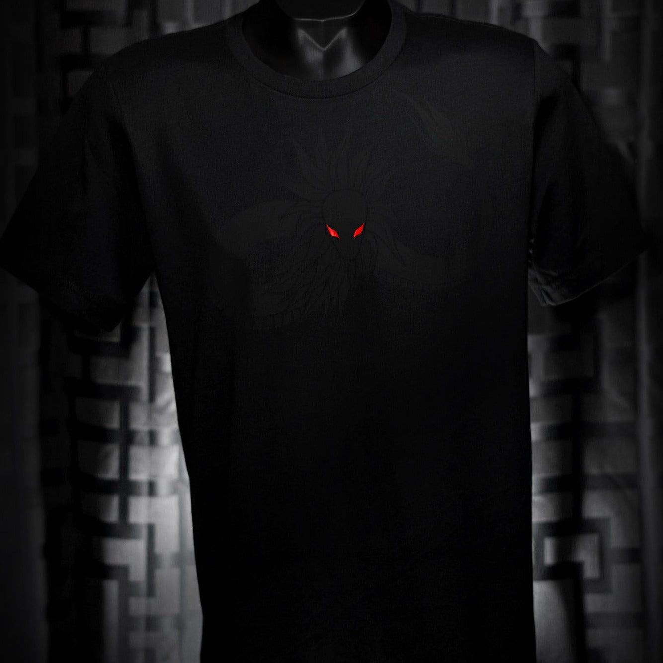 Noir et Noir Feathered Snake unisex T-shirt displayed against a dark background, emphasizing the detailed black-on-black feathered snake design and the shirt's elegant fit. Capturing the essence of the Design Collection