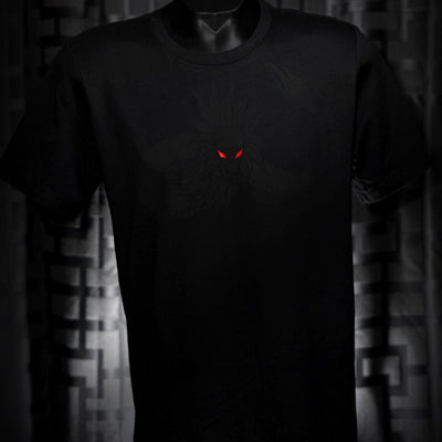 Noir et Noir Feathered Snake unisex T-shirt displayed against a dark background, emphasizing the detailed black-on-black feathered snake design and the shirt's elegant fit. Capturing the essence of the Design Collection