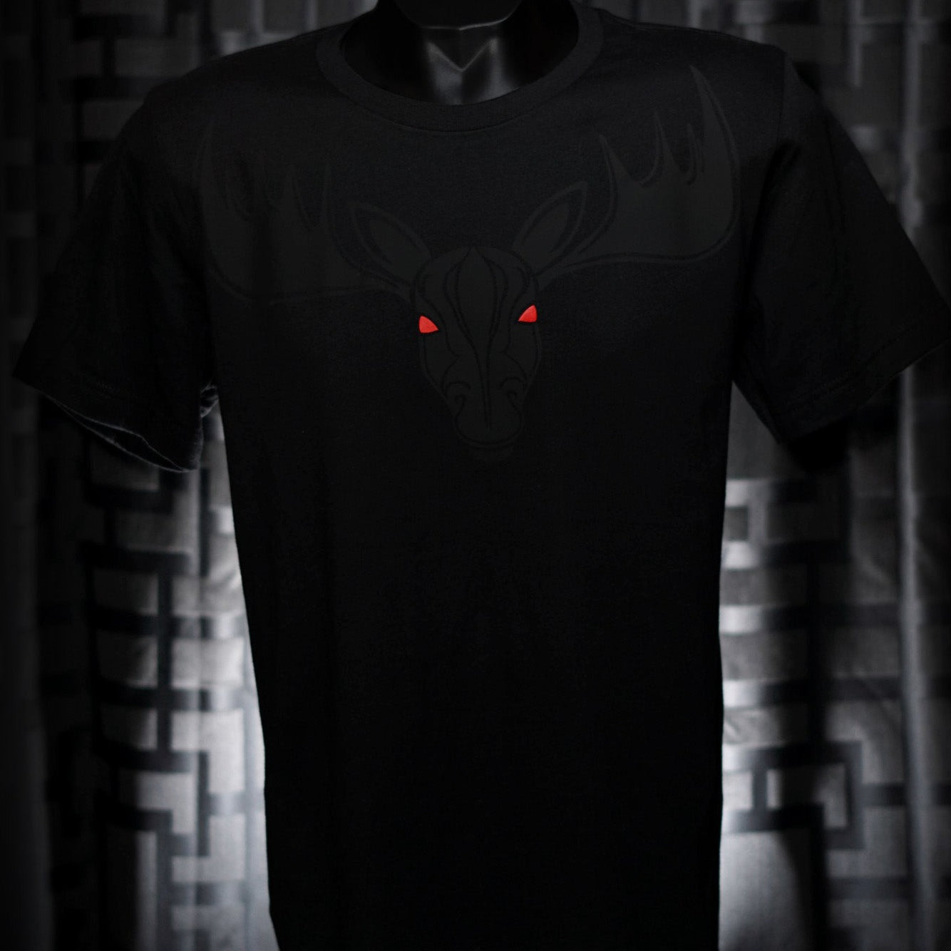Noir et Noir Moose unisex T-shirt displayed against a dark background, emphasizing the detailed black-on-black moose design and the shirt's elegant fit. Capturing the essence of the Design Collection.