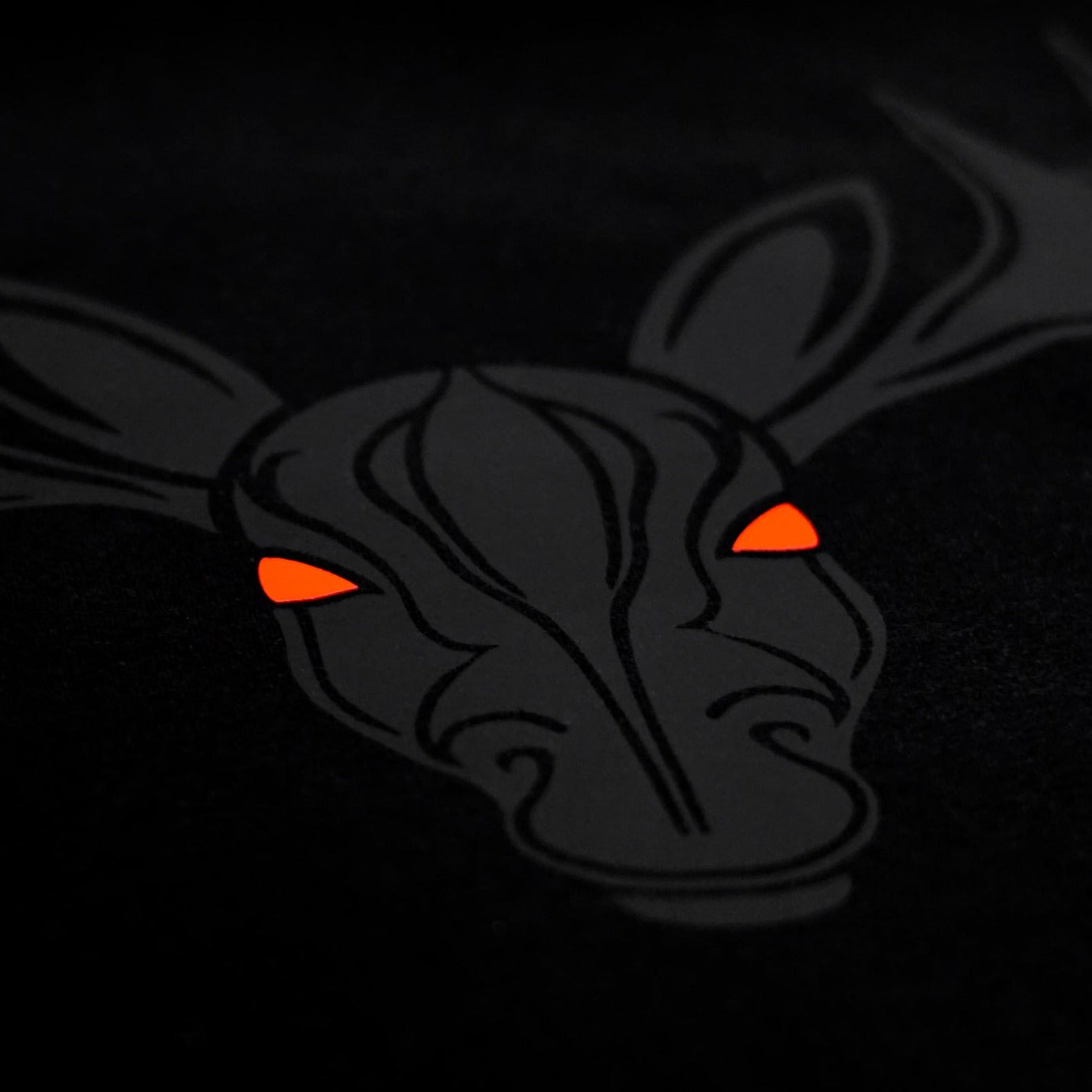 Close-up of the Noir et Noir Moose unisex T-shirt, highlighting the intricate black-on-black moose print. Perfect for those who appreciate subtle yet striking style. Part of the exclusive Design Collection.
