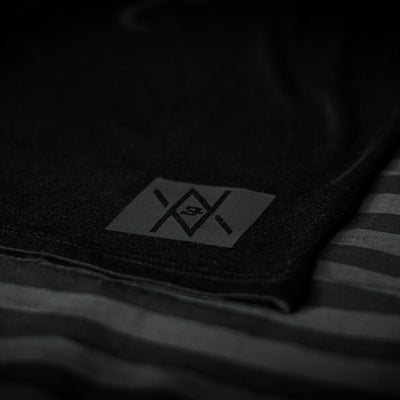Detailed view of the Noir et Noir Octopus unisex T-shirt's black-on-black logo, highlighting the precision and quality of the print. Essential for a modern, minimalist wardrobe. Featured in the Design Collection