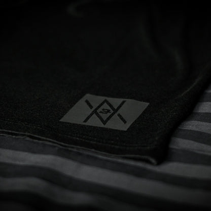 Detailed view of the Noir et Noir Moose unisex T-shirt's black-on-black logo, highlighting the precision and quality of the print. Essential for a modern, minimalist wardrobe. Featured in the Design Collection