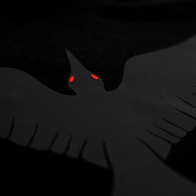 Close-up of the Noir et Noir Raven unisex T-shirt, highlighting the intricate black-on-black raven print. Perfect for those who appreciate subtle yet striking style. Part of the exclusive Design Collection.