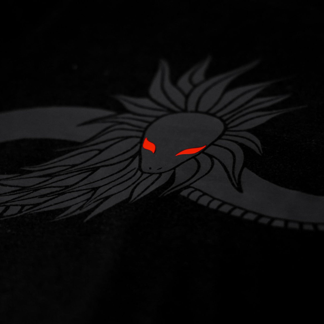 Close-up of the Noir et Noir Feathered Snake unisex T-shirt, highlighting the intricate feathered snake black-on-black print. Perfect for those who appreciate subtle yet sophisticated style. Part of the exclusive Design Collection