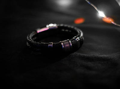 Black Woven Leather Bracelet with woven leather rows, stainless steel beads, twine details, and magnetic lobster clasp closure.